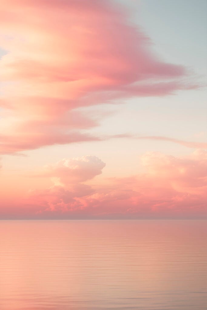 Pink clouds over water